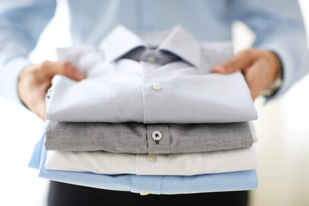 close up of businessman holding shirts